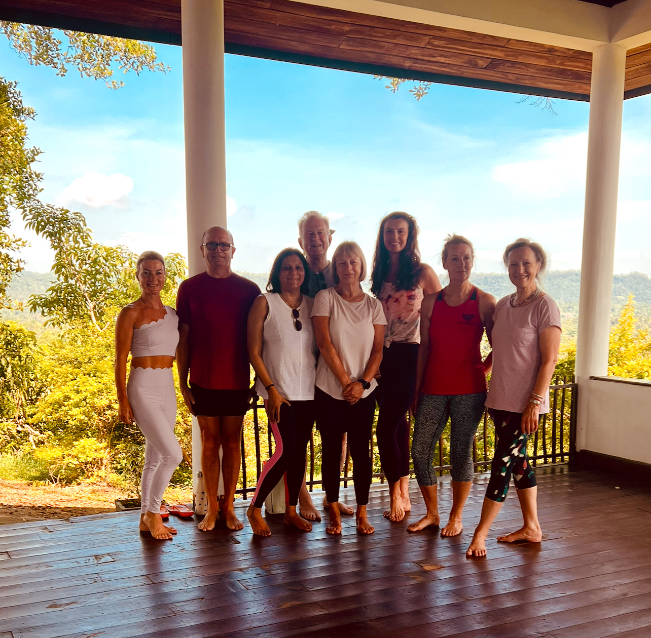 Retreat visitors stand smiling at the camera after a relaxing wellness week