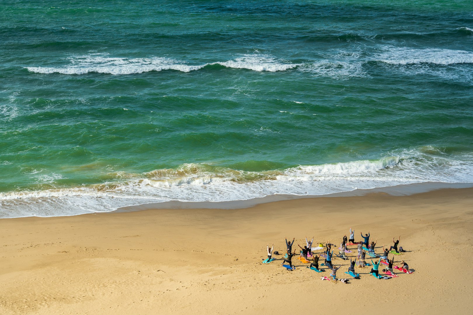 Yoga group enjoy relaxing session on the beach